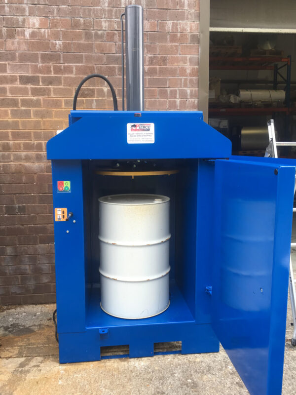 drum crusher in blue with a drum beneath