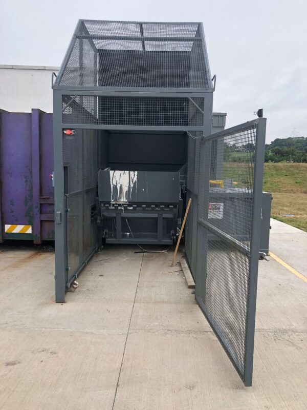 Static Compactor Loaded by Integrated Wheelie Bin Lift fully enclosed by Cage