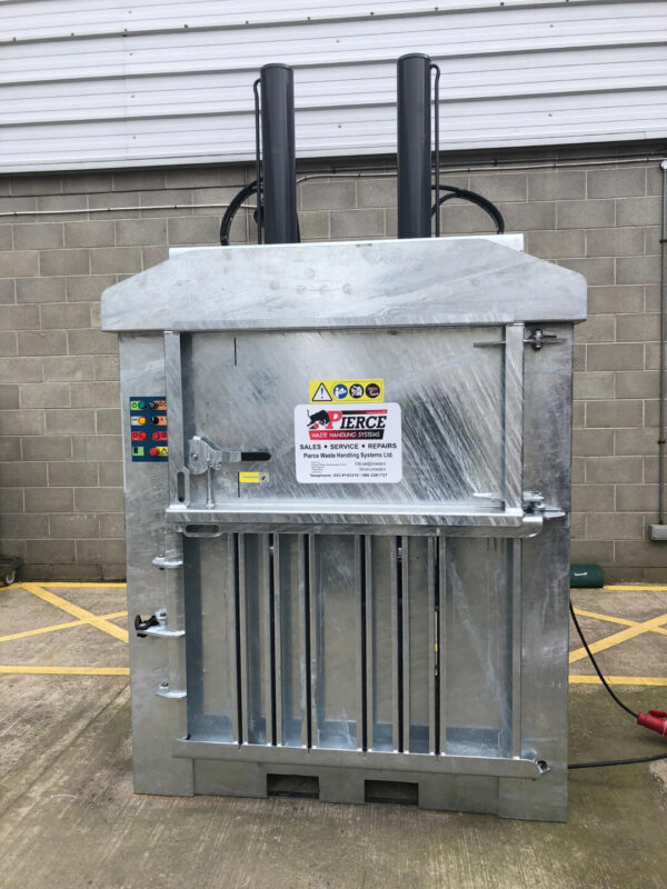 A galvanised baler with a pierce waste sticker on it