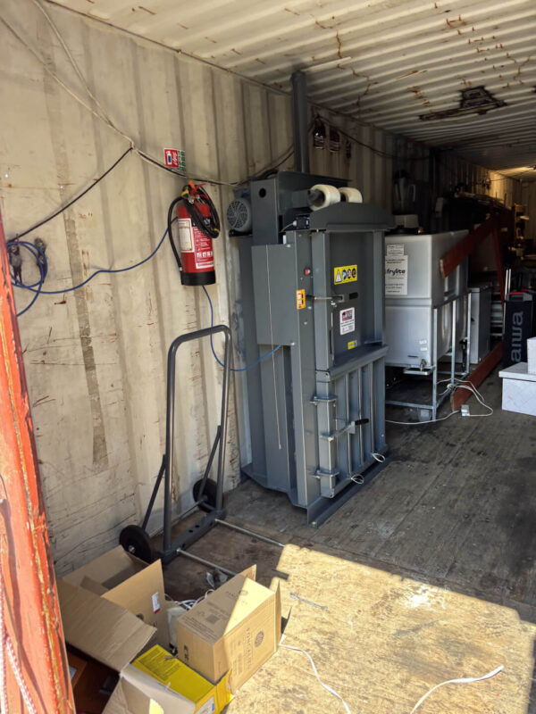50-60kg baler in black/grey installed inside container